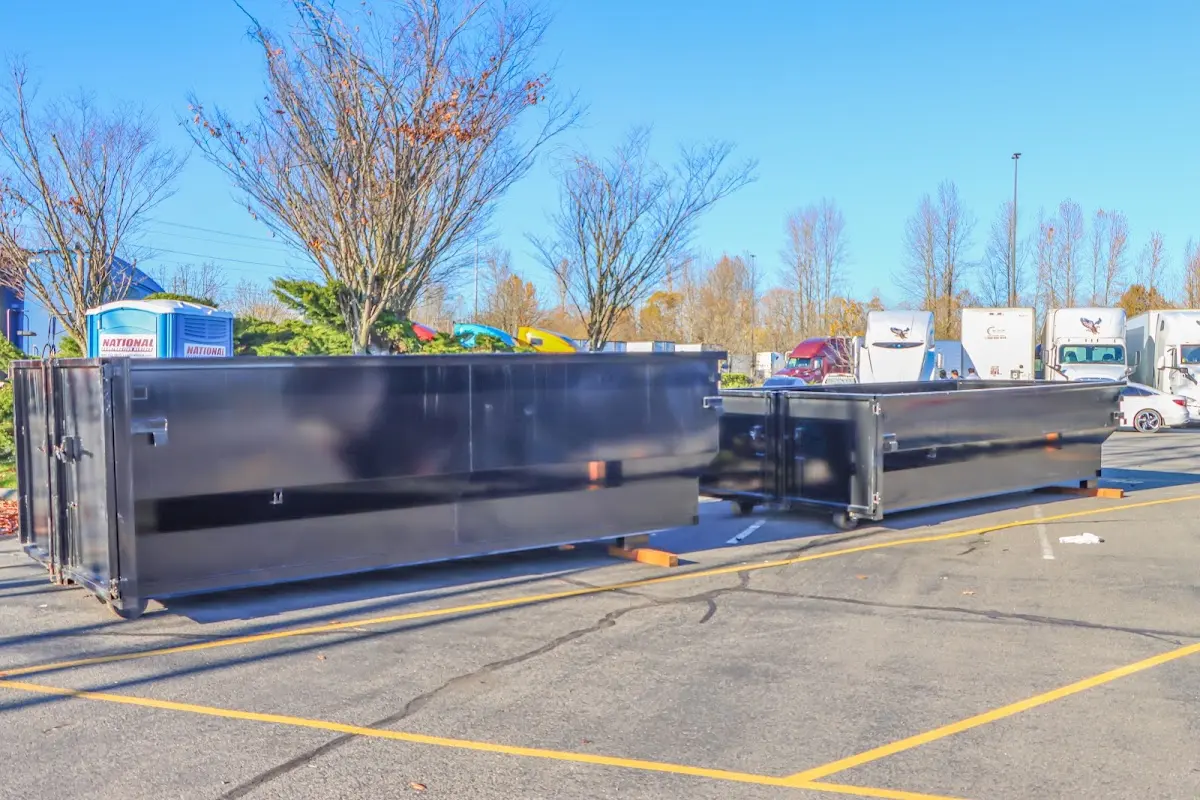 Professional dumpster rental service with roll-off container on residential driveway in Chester